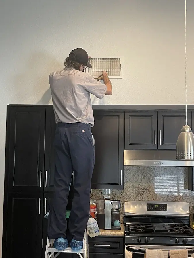 Technician inspecting an air vent during HVAC service in Susquehanna